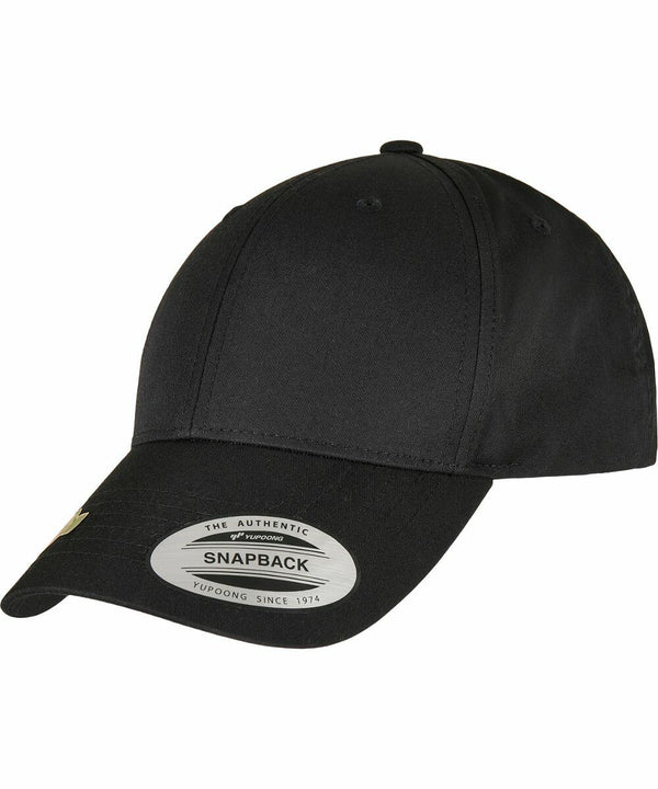 A black snapback cap with a curved brim and a sticker on the front displaying the Flexfit By Yupoong brand and "YP244.