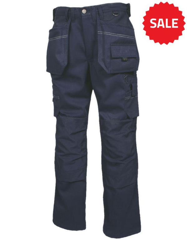Image of a pair of Tranemo TR7020_50 dark blue cargo pants featuring multiple pockets, including two large front pockets, a side cargo pocket with a flap, and additional smaller pockets. The material appears durable, suitable for outdoor or heavy-duty activities.
