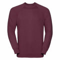 Displayed against a white background is the 7620M sweatshirt by Russell, featuring a plain maroon design with long sleeves and a crew neckline.