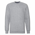 The Russell 7620M is a plain gray long-sleeve sweatshirt featuring a crew neckline, showcased against a white background. The fabric looks soft and comfortable, complemented by ribbed cuffs and hem.