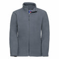 A product from Russell, the 8700B, is displayed on a white background. It features a gray fleece jacket with long sleeves, a full front zipper, and a high collar. A small logo tag is placed near the neckline.