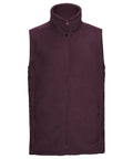 A sleeveless fleece vest known as the 8720M by Russell is featured in deep purple with a front zipper. It includes a high collar and two zippered pockets, displayed against a plain white background.