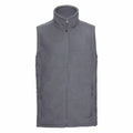 The Russell 8720M fleece vest features a gray design with a high collar and front zipper. It includes two zippered side pockets, offering a simple, casual look. The fabric is soft, making it ideal for cool weather.
