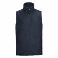 The Russell 8720M is a navy blue fleece vest featuring a high collar and front zipper. It includes two zippered pockets on each side and is crafted to be soft and comfortable, ideal for warmth and layering.