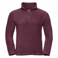 The Russell 8740M is a maroon zip-up collar fleece pullover featuring long sleeves and side zippered pockets.