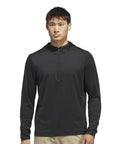 A person faces forward wearing an adidas Lightweight hoodie—a black, long-sleeve, zip-up style with a hood, crafted from lightweight athletic material—against a plain white background.