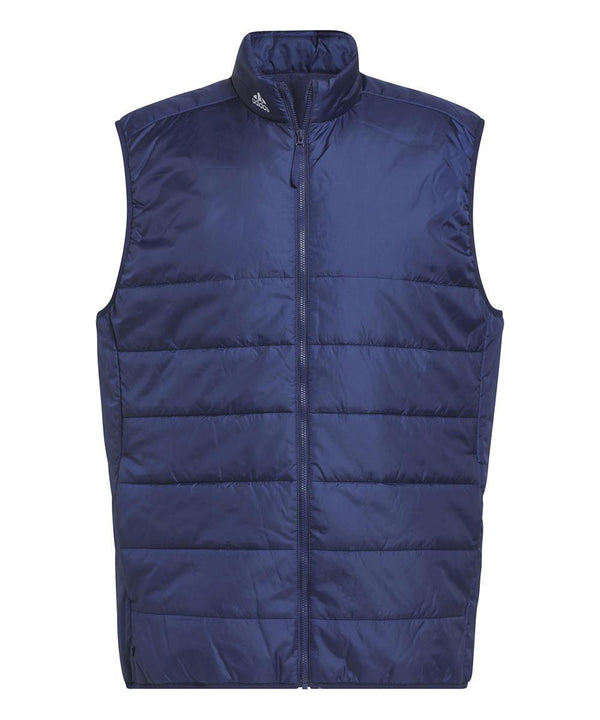 The adidas Puffy gilet is a sleeveless, navy blue puffer with horizontal quilting, a high collar, full front zip, and a subtle logo near the collar. Made from shiny, lightweight material for stylish comfort.