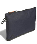 The adidas Valuables pouch is a rectangular, dark blue zippered pouch with a black bottom and an orange zip pull, shown standing upright against a white background.