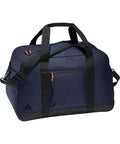 A navy blue Bags duffel features black straps, a black base, front zip pocket with orange pulls, two short handles, an adjustable shoulder strap, and an Adidas logo in the corner.