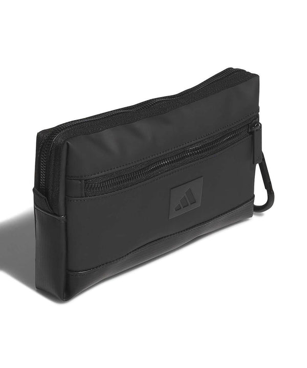 The adidas 1st tee pouch is a black rectangular zipped pouch with a front zip pocket, side carabiner clip, and adidas logo, shown against a white background.