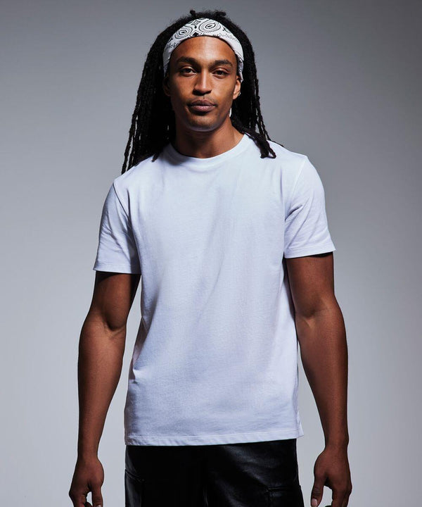 A man with long dreadlocks stands against a neutral background. He is wearing a plain white T-shirt and black pants. A white bandana with a patterned design, Anthem's AM012, is tied around his forehead. He is looking directly at the camera with a calm expression.
