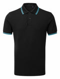 The Asquith & Fox AQ011 black polo shirt has short sleeves, a classic collar with three buttons, and light blue stripes accenting the edges of both the collar and sleeves. It is showcased against a plain white background.