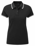 The AQ021 by Asquith & Fox is a black polo shirt featuring white trim on the collar and sleeves.