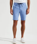 A person wearing light blue drawstring AQ057 shorts by Asquith & Fox, a white shirt, and white sneakers is standing against a plain white background.