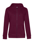 A maroon zip-up hoodie with hood, drawstrings, long sleeves, and front pockets is shown on a plain white background.