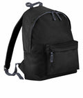 A Bagbase B125J black backpack featuring adjustable straps and a front zip pocket, shown against a white background.