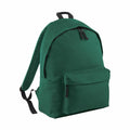 The Bagbase B125J features a green design with a front zippered pocket and black adjustable straps, set against a white background.