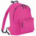 Introducing the Bagbase B125J, a vibrant pink backpack featuring sleek black zippers and adjustable straps. This stylish backpack offers a spacious main compartment paired with a convenient smaller front pocket. It stands upright, highlighting its minimalist yet functional design.
