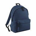 A Bagbase B125L navy blue backpack featuring a front zipper pocket and adjustable black straps is displayed against a plain white background.