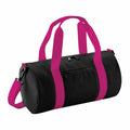 A sleek black cylindrical duffel bag, model B140S by Bagbase, featuring bright pink handles and a shoulder strap, with an additional front zipper pocket.