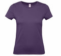 The B&C Collection's B210F women's T-shirt, featuring a solid dark purple color, short sleeves, and a crew neckline, is showcased against a white background. The design is minimalist, highlighting its casual style and vibrant hue.