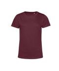 A maroon T-shirt top with short sleeves and a round neckline is shown against a white background, featuring a clean and simple design.