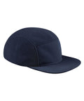 The Caps product is a navy blue five-panel cap with a flat peak, crafted from smooth and textured fabric, displayed on a white background.