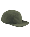 The Cap is an olive green five-panel cap featuring a flat peak and a combination of textured and smooth fabric panels, displayed from the side on a plain white background.