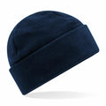 The Beechfield B243R is a navy blue fleece beanie hat featuring a folded brim, set against a white background.