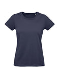 A women's T-shirt in navy blue is shown against a white background, featuring short sleeves, a round neckline, and a fitted cut.