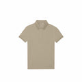 The B&C Collection's B265F is a beige, short-sleeved polo shirt featuring a collar. It is laid flat on a white background, highlighting the front and buttons clearly.