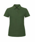 A B306F by B&C Collection, featuring a green polo shirt with short sleeves and a collar, displayed on a white background.