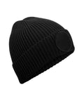 The Beanies is a black, ribbed knit hat featuring a wide folded cuff and a circular front patch, shown on a plain white background.