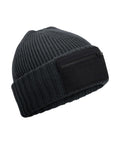 The Beanies is a dark grey ribbed knit hat with a wide turn-up and a black rectangular patch featuring a front zip pocket.