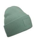 Light green beanies with a ribbed knit design, folded brim, and blank rectangular patch on the front, displayed against a white background.