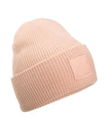 The Beanies is a light pink knitted hat featuring a folded brim and rectangular front patch, displayed on a white background.