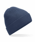 A Beechfield B376R blue ribbed-knit beanie with a rolled cuff is shown against a white background, exuding warmth and comfort with its simple and classic design.