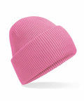 A Beechfield B385R pink knit beanie featuring a folded brim, set against a white background.