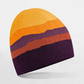 The B394R knit beanie from Beechfield features horizontal stripes in yellow, orange, and purple on a white background.