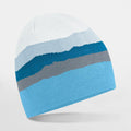 A Beechfield B394R beanie hat featuring white, gray, and blue stripes set against a plain white backdrop.