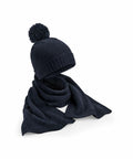 A Beechfield B401R dark knitted beanie with a pom-pom and a matching scarf are displayed on a white background.