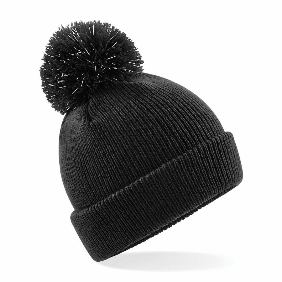 The Beechfield B406B, a black knit beanie featuring a pom-pom on top, is displayed against a plain white background.