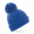 A Beechfield B406B blue knit beanie featuring a pom-pom on top.