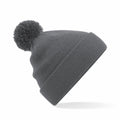 A Beechfield B426B, a knitted beanie in gray with a pom-pom on top, is displayed against a white background.