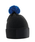 A black beanie knit hat with a blue pom-pom and a rectangular black patch on the front, displayed against a white background.