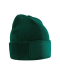 A green Beanies knitted beanie featuring a folded brim and a blank rectangular patch on the front, shown against a white background.