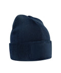 The Beanies is a dark blue knitted hat with a folded cuff and a rectangular blank patch on the front, shown against a plain white background.