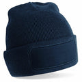 A navy blue Beechfield B445R knit beanie featuring a blank patch on the front.