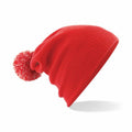 The Beechfield B450B red knit beanie, featuring a pom-pom on the tip, is showcased against a plain white background.