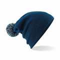 The Beechfield B450B blue knitted beanie, featuring a pom-pom on top, is displayed on a white background.